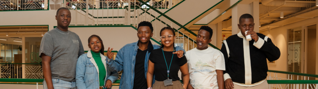 six Talent Match Africa team group picture in the building hallway