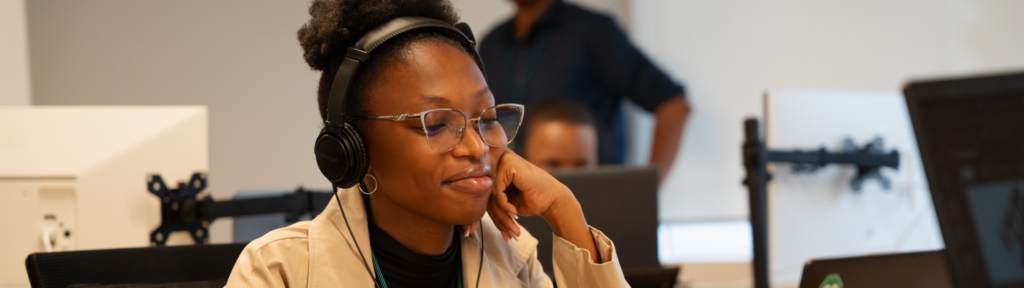 picture of female employee using headphone on her desk